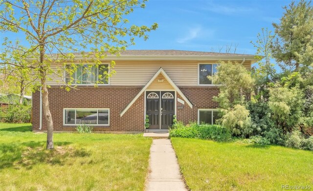 view of front facade featuring a front lawn and brick siding