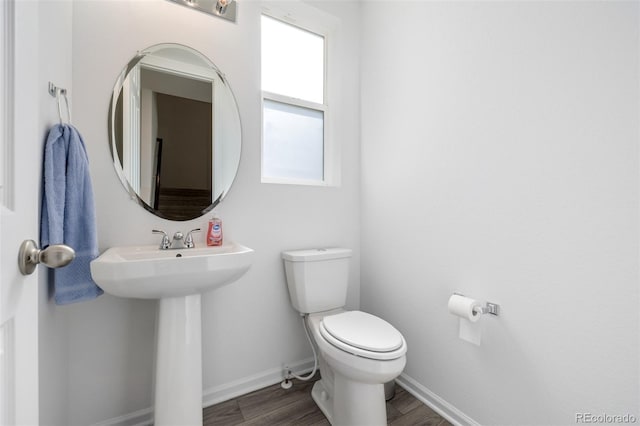 18199 E 96th Ave, Commerce City, CO 80022 - half bath with toilet, baseboards, wood finished floors, and a sink