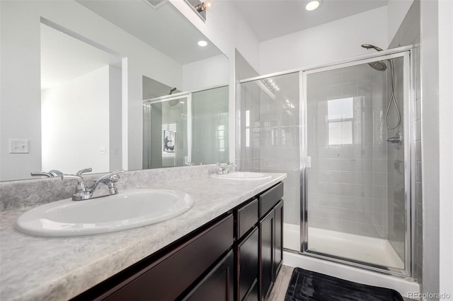 18199 E 96th Ave, Commerce City, CO 80022 - bathroom featuring a stall shower, double vanity, and recessed lighting
