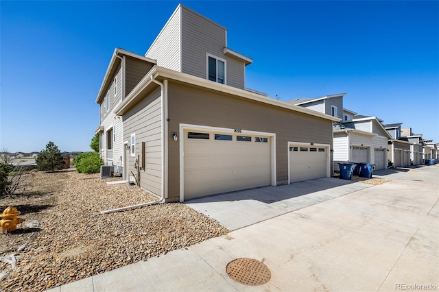 18199 E 96th Ave, Commerce City, CO 80022 - view of home's exterior with concrete driveway, central AC, and a garage