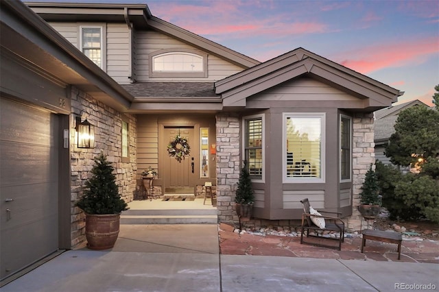 exterior entry at dusk with a patio