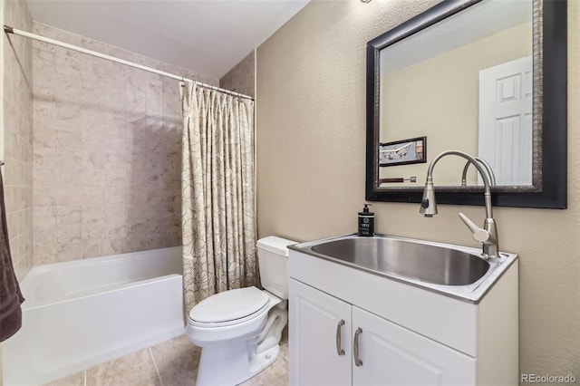 bathroom featuring toilet, shower / bathtub combination with curtain, vanity, a textured wall, and tile patterned flooring