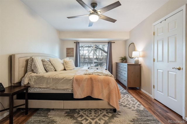 bedroom featuring a ceiling fan, baseboards, and wood finished floors