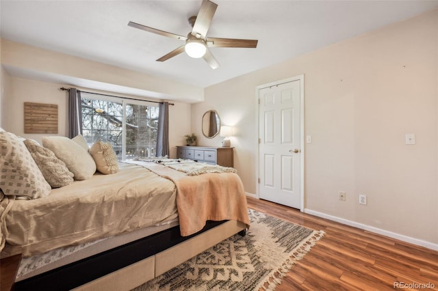 bedroom featuring ceiling fan, baseboards, and wood finished floors