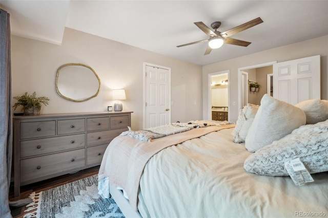 bedroom with ceiling fan, wood finished floors, and ensuite bathroom