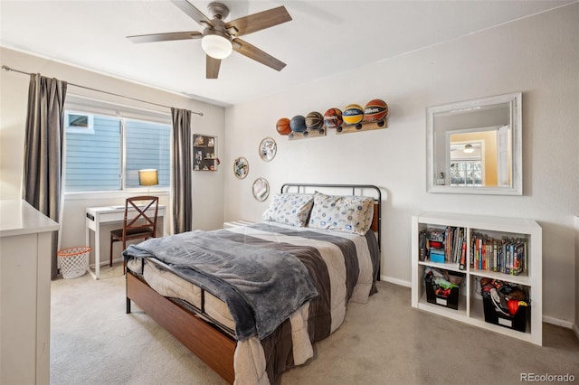 bedroom featuring light carpet, multiple windows, and baseboards