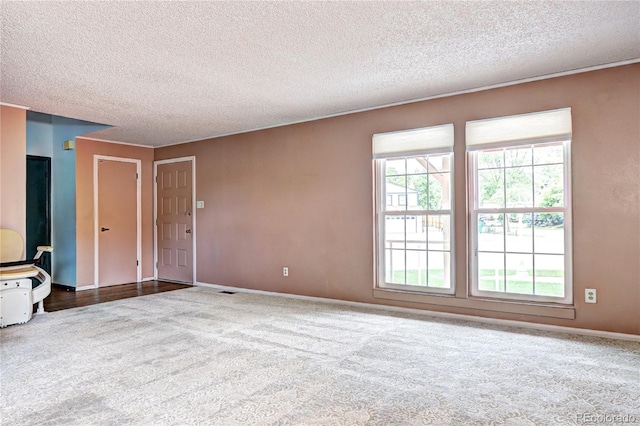 7300 Beech St, Arvada, CO 80005 - unfurnished living room featuring carpet flooring, a textured ceiling, and baseboards