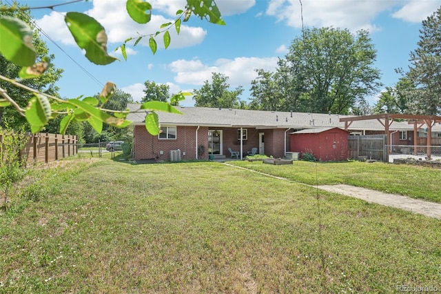 4715 Garland St, Wheat Ridge, CO 80033 - back of property with a fenced backyard, brick siding, and a storage unit
