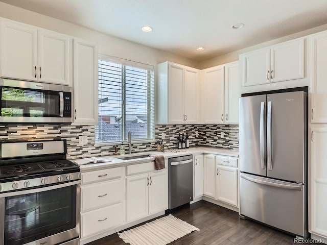 2507 Moline St, Aurora, CO 80010 - kitchen with appliances with stainless steel finishes, a sink, light countertops, white cabinetry, and tasteful backsplash