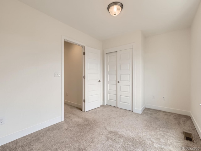 2507 Moline St, Aurora, CO 80010 - unfurnished bedroom featuring light carpet, a closet, and baseboards