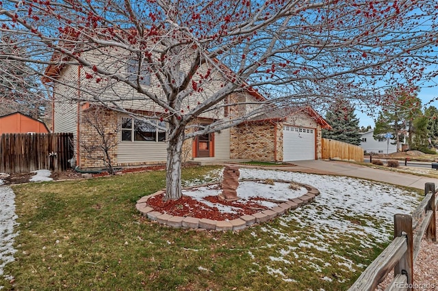 view of front of house with a front lawn, fence, concrete driveway, an attached garage, and brick siding