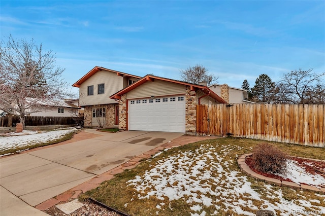 view of front facade with brick siding, driveway, an attached garage, and fence