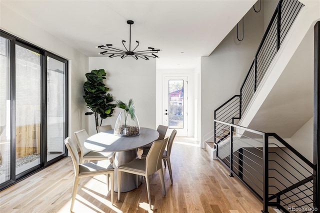 dining space featuring a chandelier, plenty of natural light, and light hardwood / wood-style floors