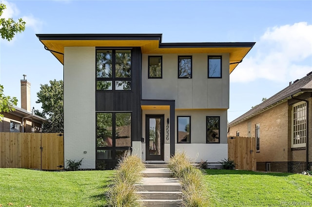 modern home featuring a front lawn