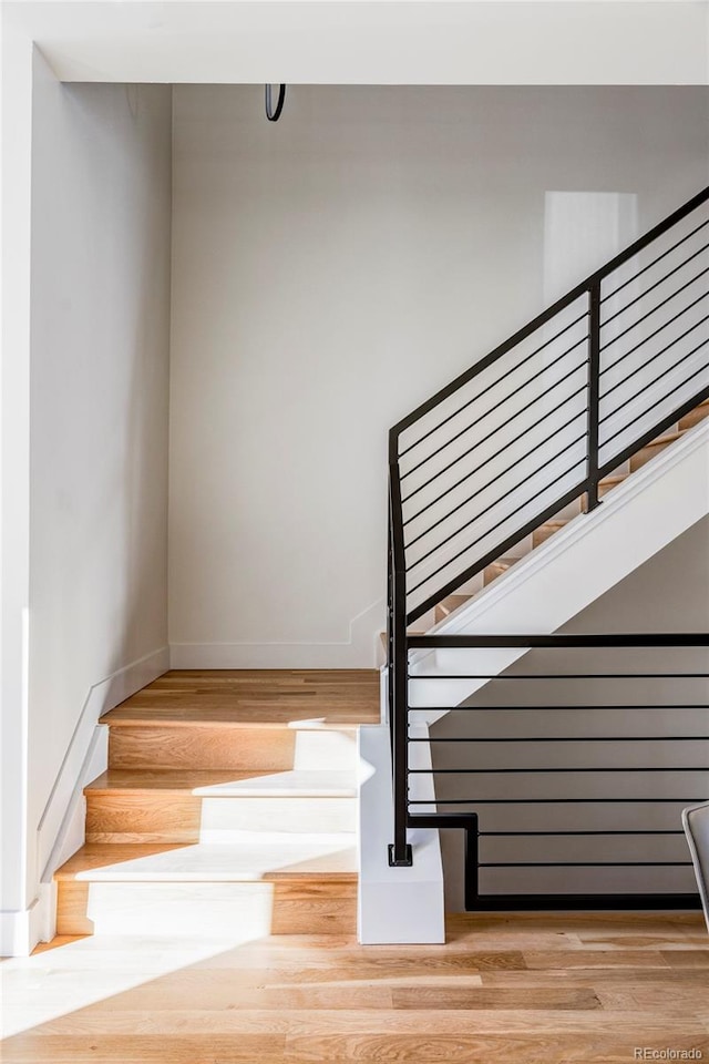 stairs featuring hardwood / wood-style flooring