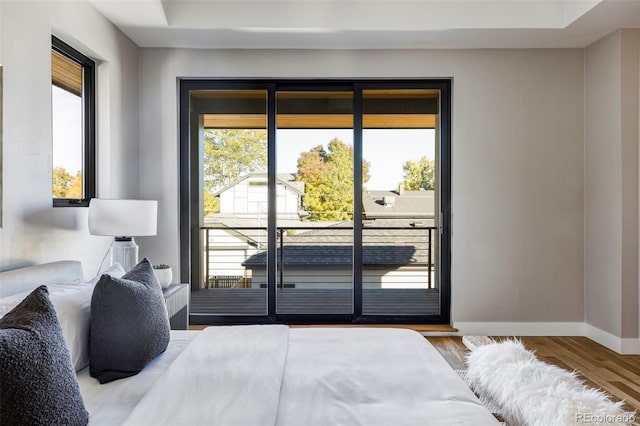 bedroom with light wood-type flooring and multiple windows