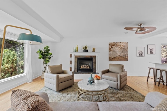 3209 E Yale Way, Denver, CO 80210 - living room with plenty of natural light, wood finished floors, a fireplace, a ceiling fan, and beamed ceiling