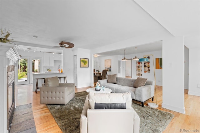 3209 E Yale Way, Denver, CO 80210 - living area featuring light wood-type flooring and a ceiling fan