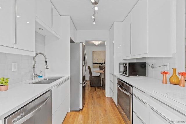 3209 E Yale Way, Denver, CO 80210 - kitchen with appliances with stainless steel finishes, white cabinetry, and light countertops
