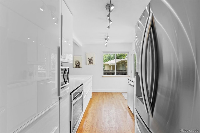 3209 E Yale Way, Denver, CO 80210 - kitchen with appliances with stainless steel finishes, modern cabinets, and white cabinets