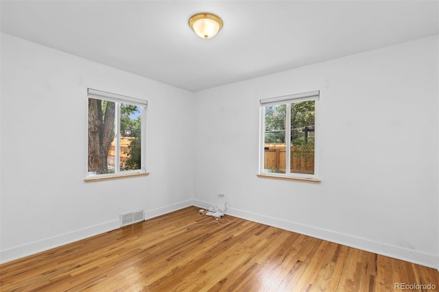 3209 E Yale Way, Denver, CO 80210 - spare room with baseboards and light wood-type flooring
