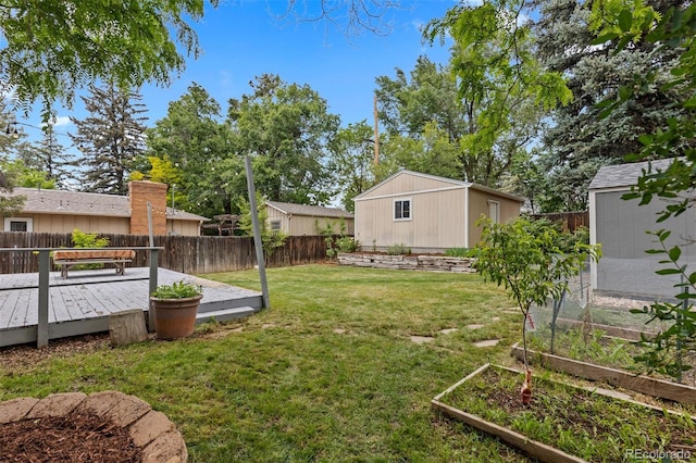 3209 E Yale Way, Denver, CO 80210 - fenced backyard with an outdoor structure, a vegetable garden, and a wooden deck