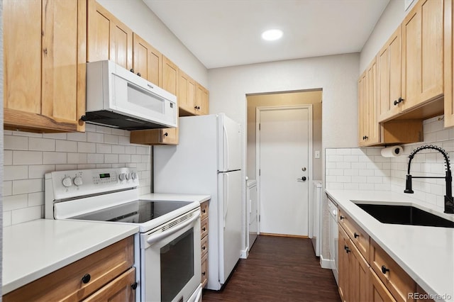 kitchen with tasteful backsplash, light countertops, light brown cabinets, a sink, and white appliances