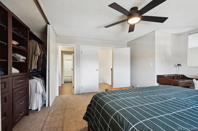 carpeted bedroom featuring a ceiling fan and a textured ceiling