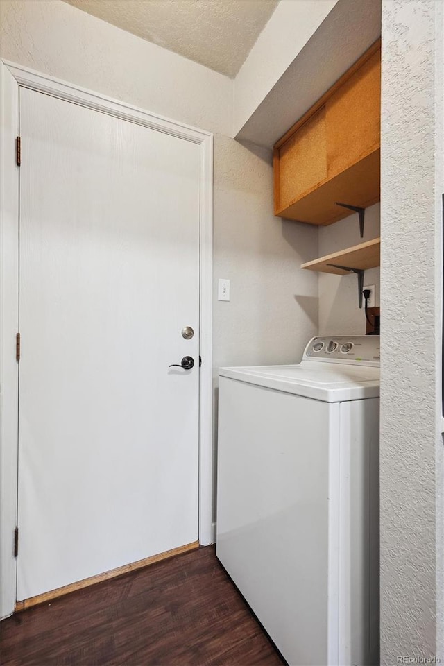 washroom featuring washer / clothes dryer, baseboards, dark wood-style flooring, and laundry area