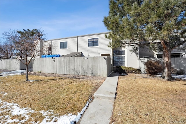 exterior space featuring a front yard and fence