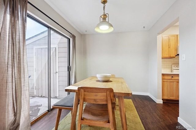 dining room with dark wood-type flooring and baseboards