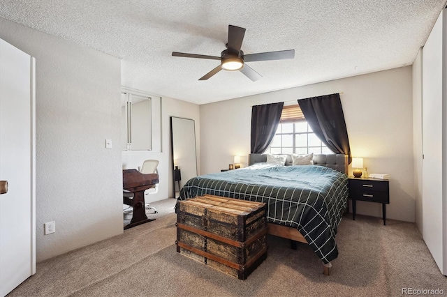 carpeted bedroom with a textured ceiling and a ceiling fan