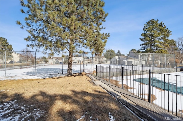 pool with a patio, fence, and a residential view