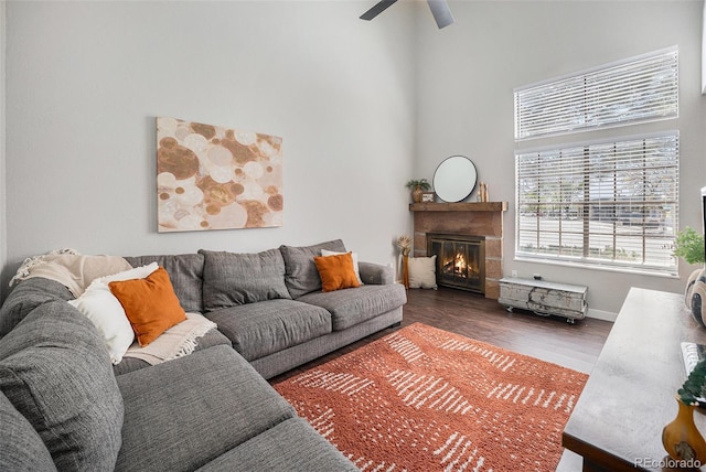 7705 W 87th Dr, Arvada, CO 80005 - living room with a high ceiling, wood finished floors, a glass covered fireplace, and a ceiling fan