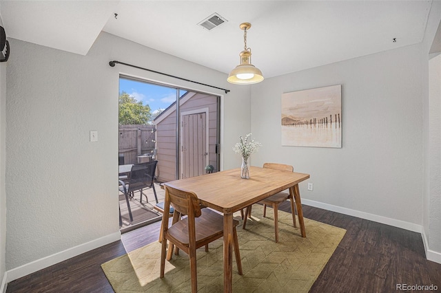 7705 W 87th Dr, Arvada, CO 80005 - dining area featuring dark wood finished floors and a textured wall