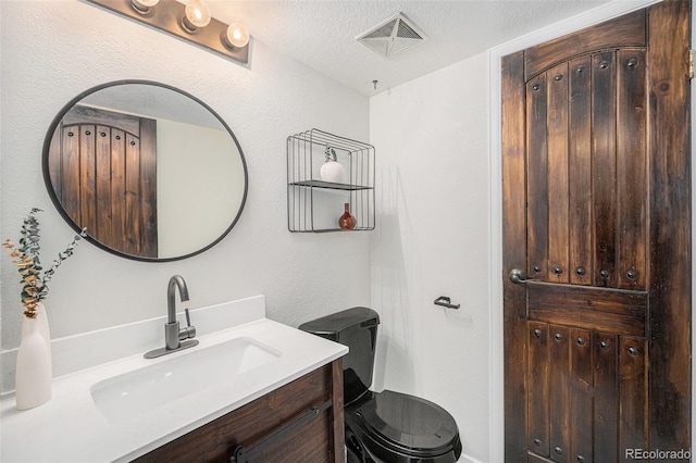 7705 W 87th Dr, Arvada, CO 80005 - bathroom with vanity and a textured ceiling