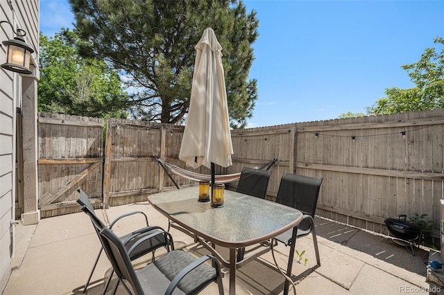7705 W 87th Dr, Arvada, CO 80005 - fenced backyard with outdoor dining space and a patio
