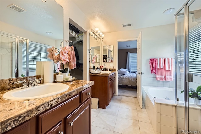13626 Garfield St Unit A, Thornton, CO 80602 - ensuite bathroom featuring a stall shower, tile patterned floors, vanity, and a bath