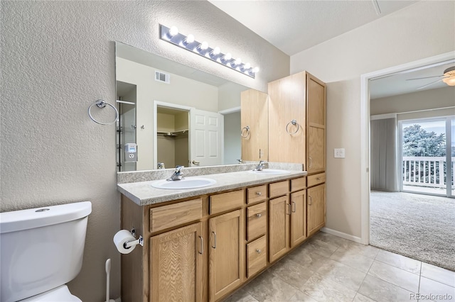 bathroom featuring tile patterned flooring, ceiling fan, toilet, and vanity