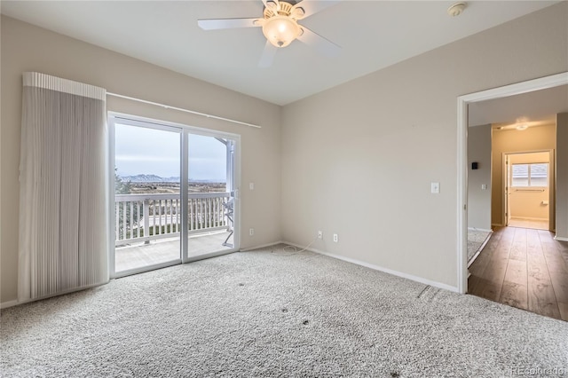 spare room with ceiling fan and dark hardwood / wood-style flooring