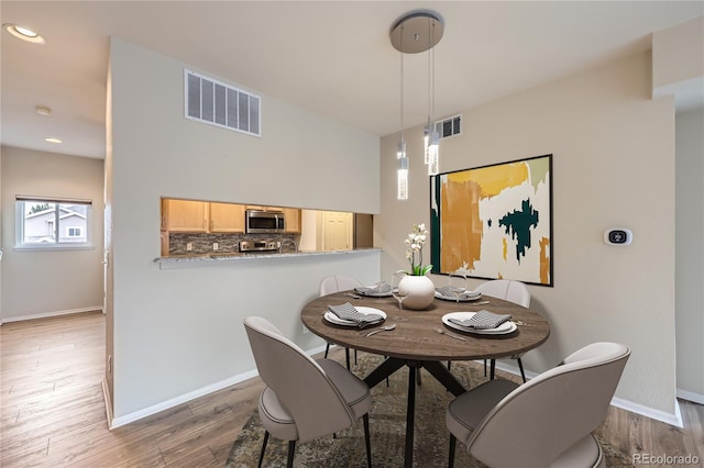 dining space featuring hardwood / wood-style floors