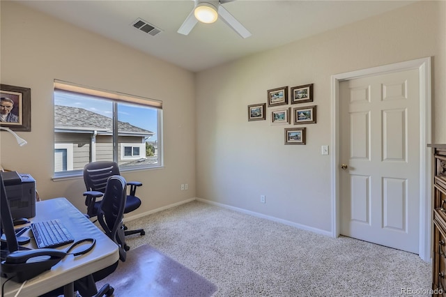 office space featuring light carpet and ceiling fan