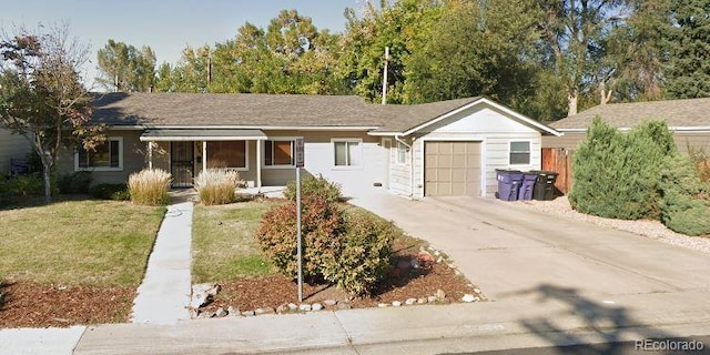 ranch-style home featuring a garage and a front yard