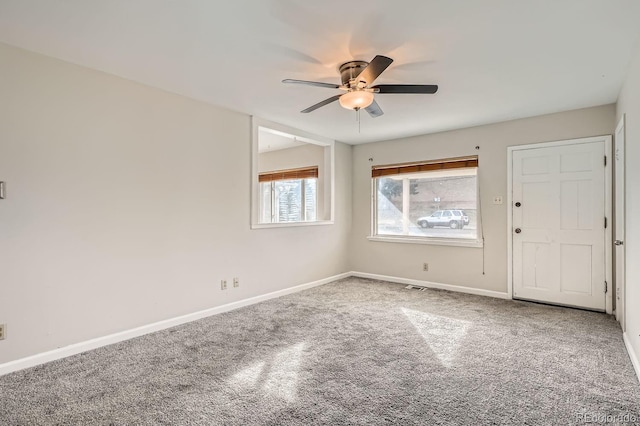 spare room with carpet floors and ceiling fan