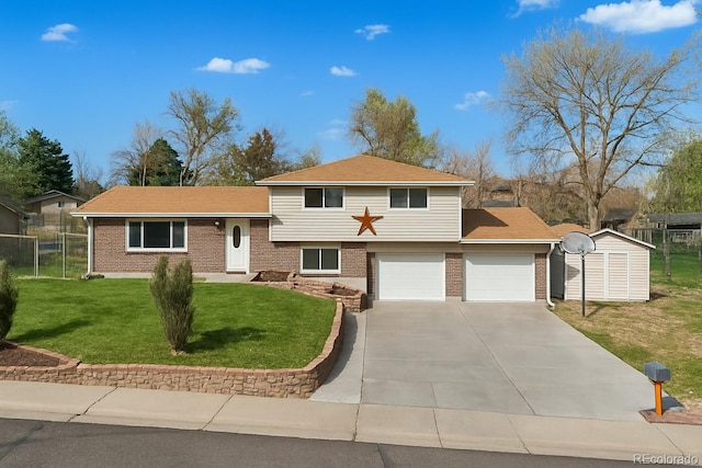 tri-level home with fence, driveway, brick siding, a front yard, and a garage