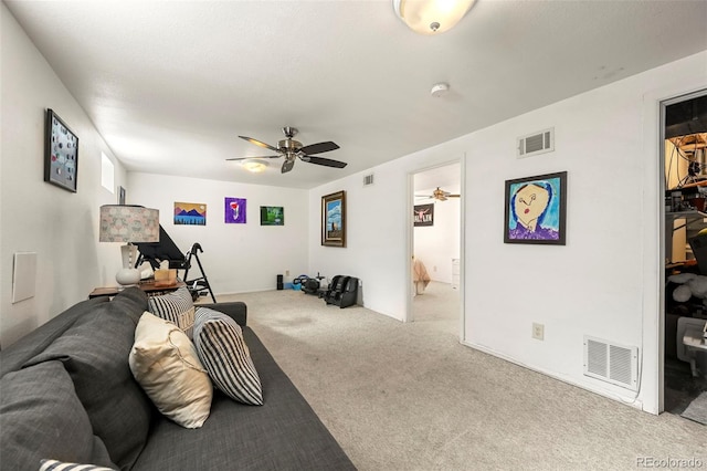 living room featuring carpet, visible vents, and a ceiling fan