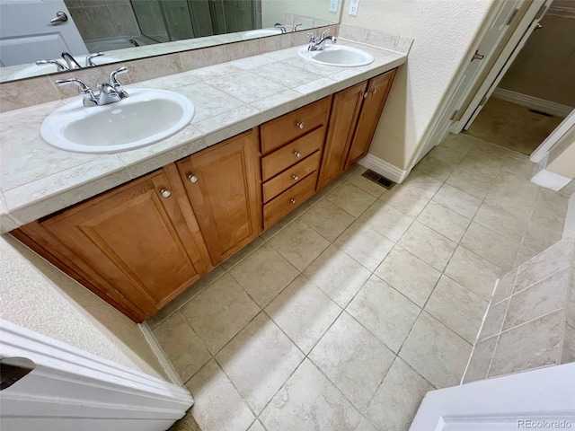 bathroom with tile patterned flooring and vanity