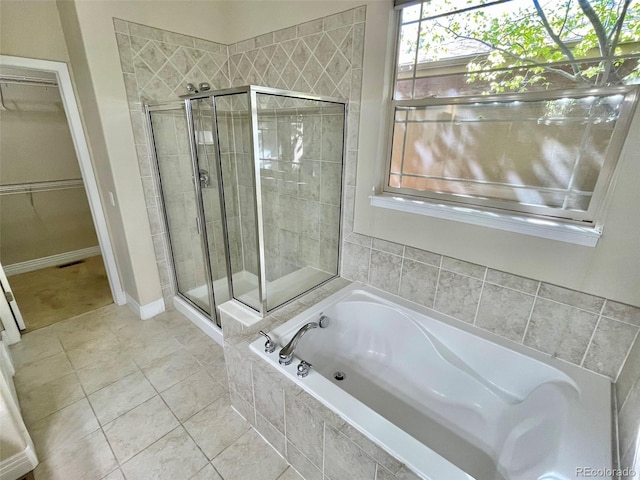 bathroom featuring tile patterned flooring and separate shower and tub