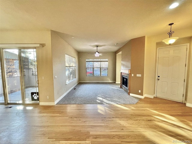 unfurnished living room with light hardwood / wood-style floors and ceiling fan