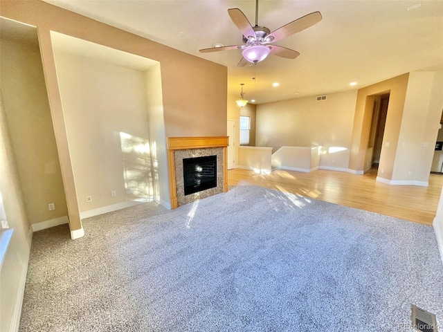 unfurnished living room with light hardwood / wood-style floors and ceiling fan